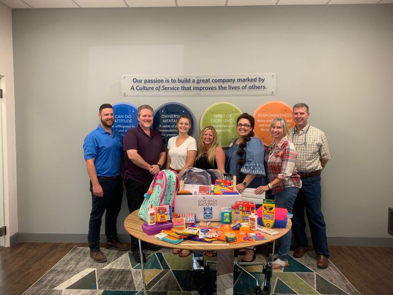 Foresight team members packing backpacks to support local Back-to-School drives